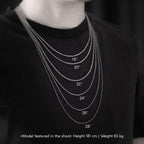 A close-up of a person's neck wearing a necklace with multiple chains of varying sizes, as indicated by the numbers on the chains.
