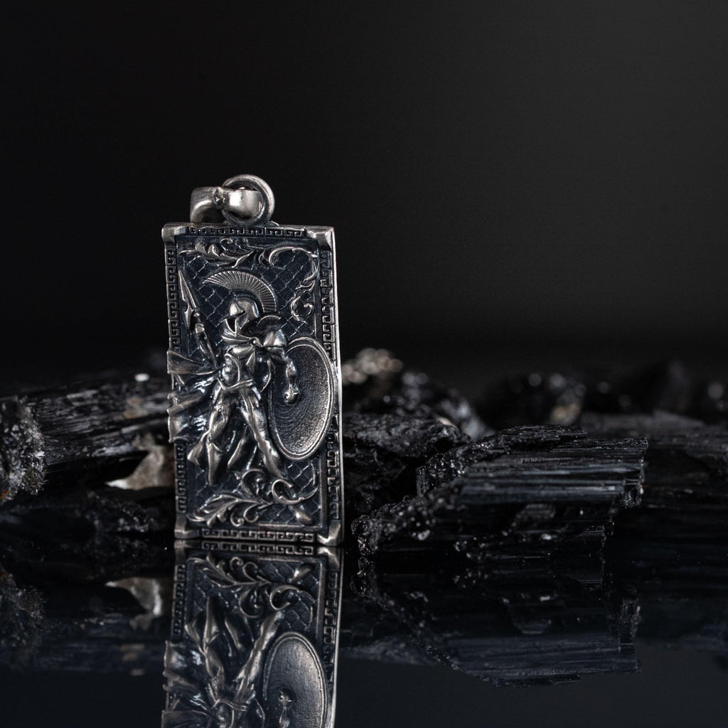 Spartan Warrior Pendant in 925 Sterling Silver, intricately designed with a warrior holding a shield, set against a dark background with reflective surface.